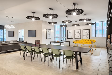 a large dining room with a long table and chairs