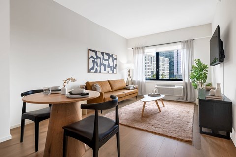 A modern living room with a wooden table and chairs.