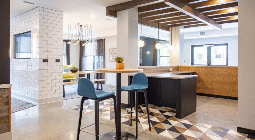 a kitchen and dining area with blue chairs and a table
