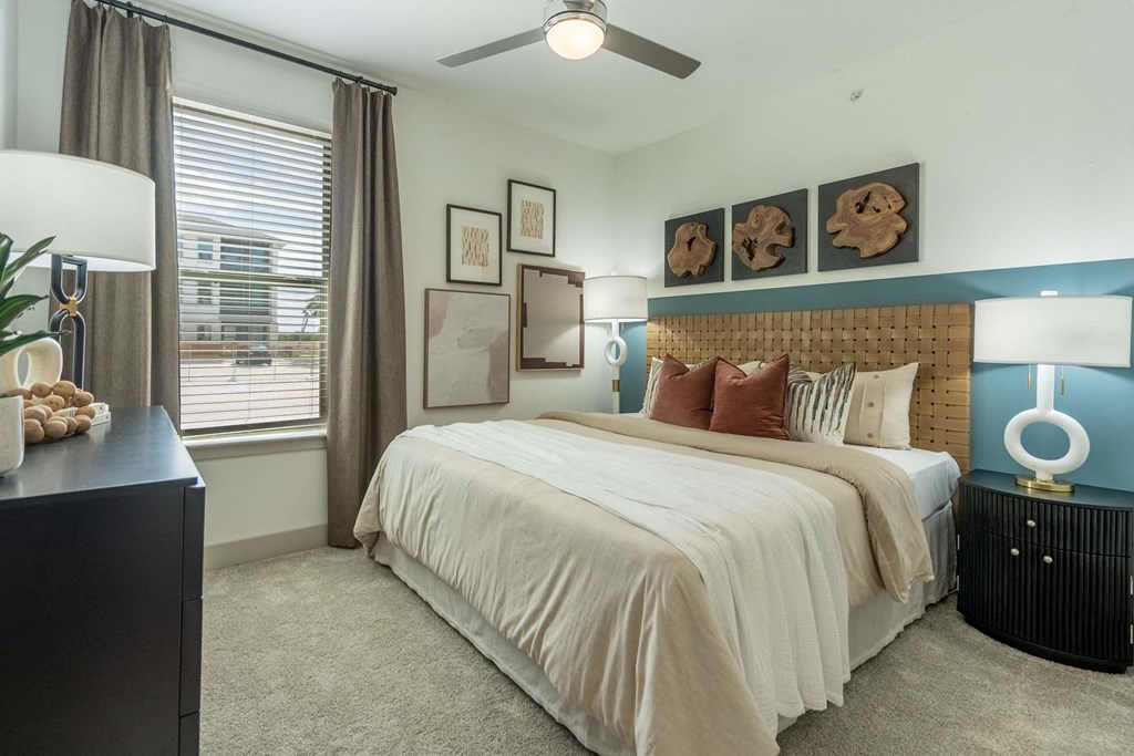 a bedroom with a bed and a ceiling fan