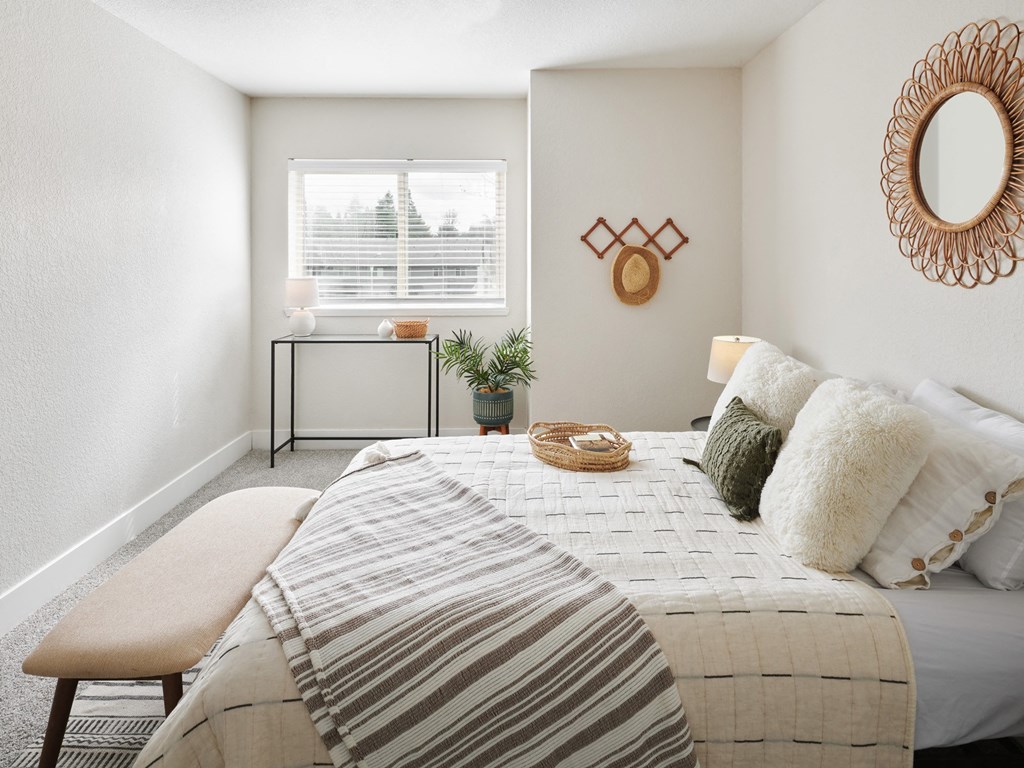 a bedroom with a bed and a window