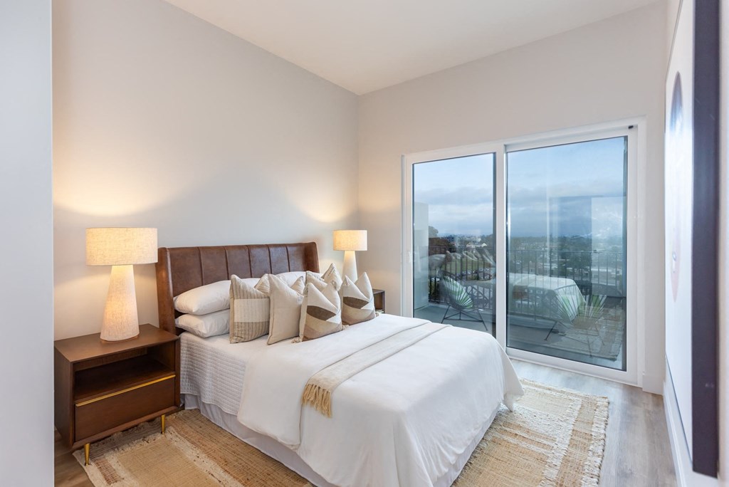 a bedroom with a large bed and a large window