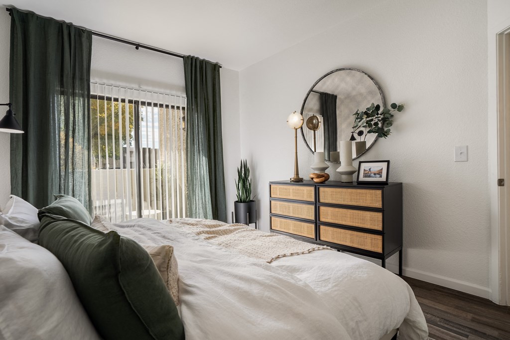 a bedroom with a bed and a dresser and a window