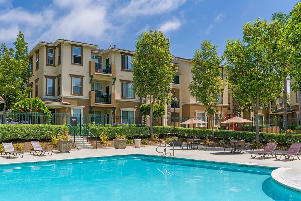 A swimming pool in front of apartment buildings.