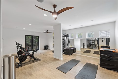 A spacious home gym with a variety of exercise equipment.