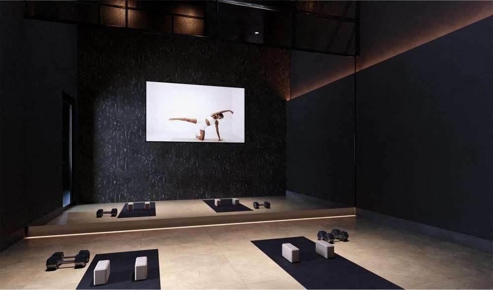 a room with yoga mats and a picture on the wall