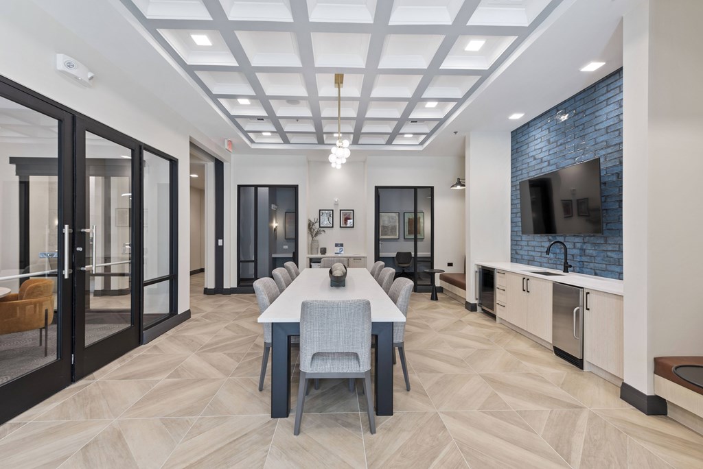 A modern kitchen with a dining table and chairs.