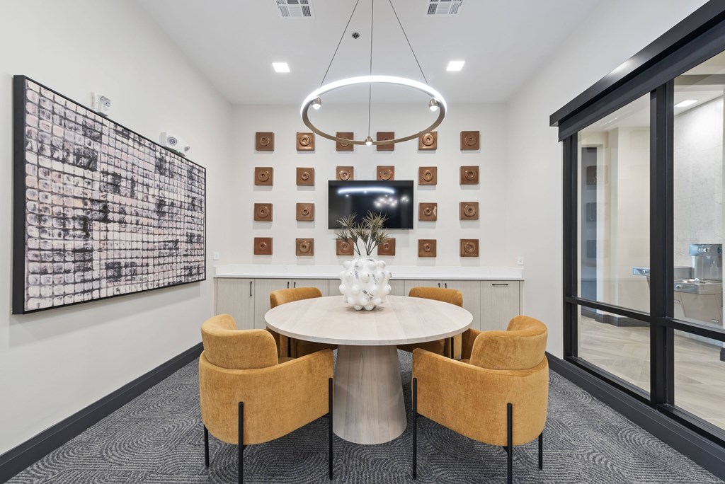 A modern conference room with a round table and chairs.