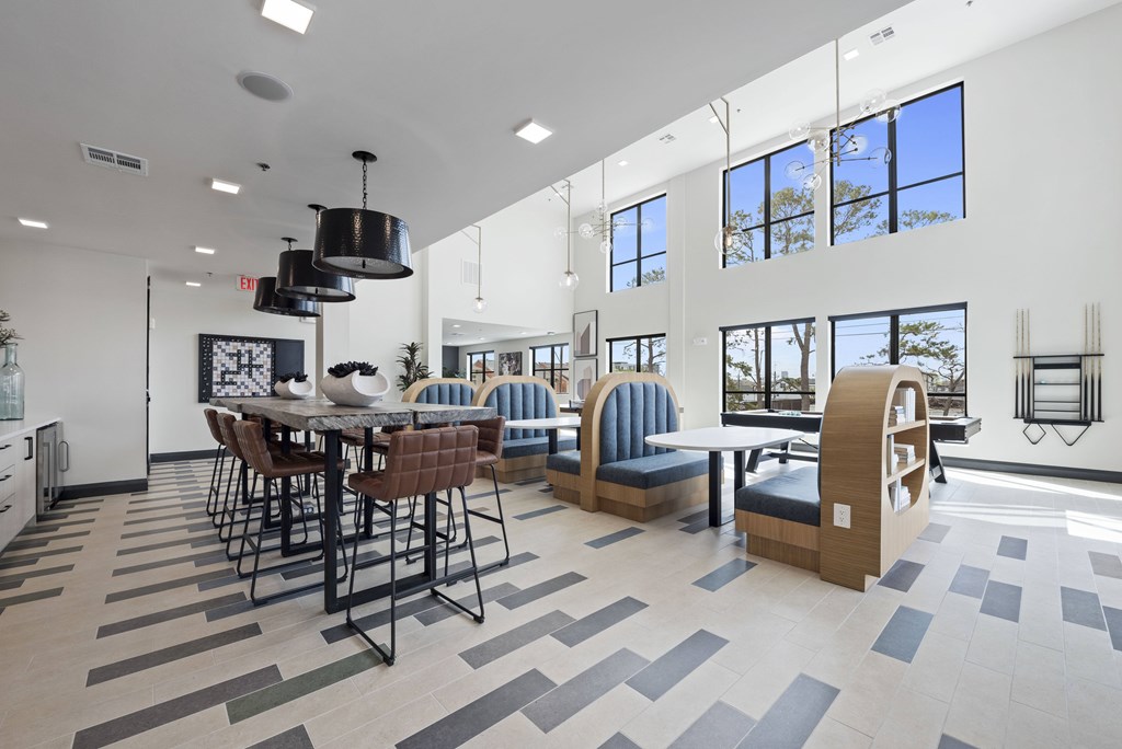 A modern dining area with a long table and chairs.