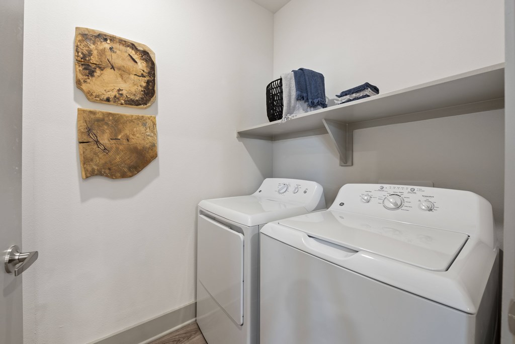 A small laundry room with a washer and dryer.