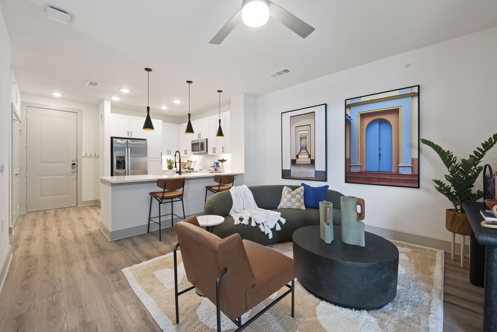 A modern living room with a brown chair and a black coffee table.