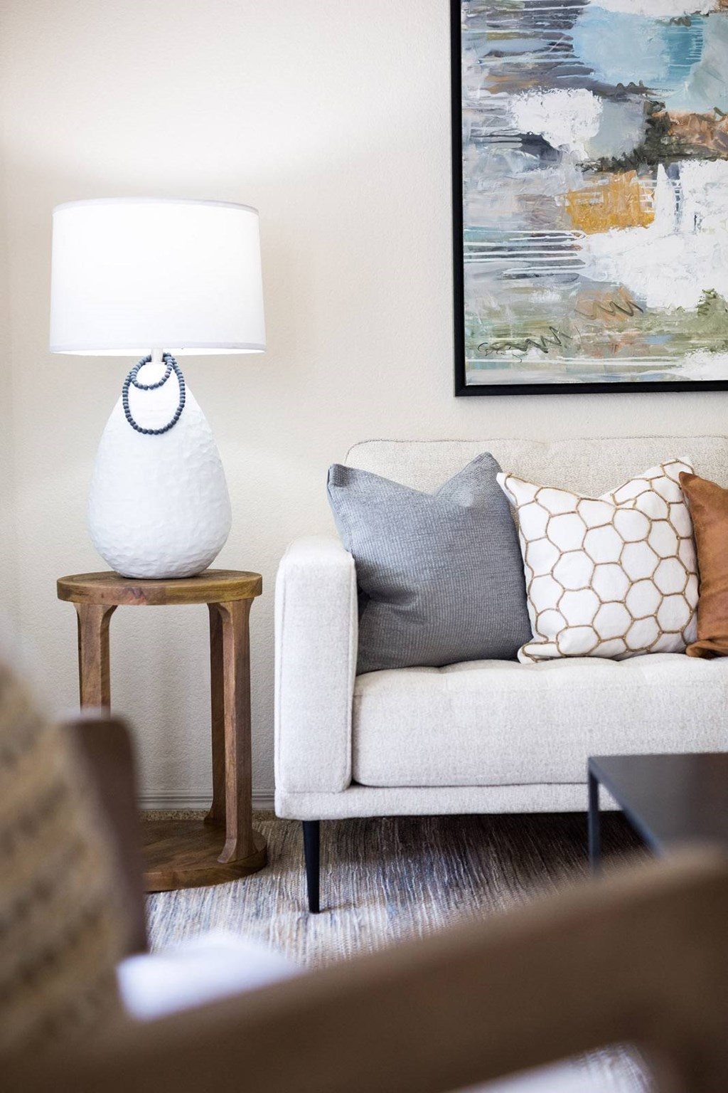 a living room with a couch and a lamp