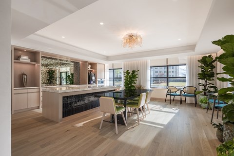 A modern kitchen with a dining table and chairs.