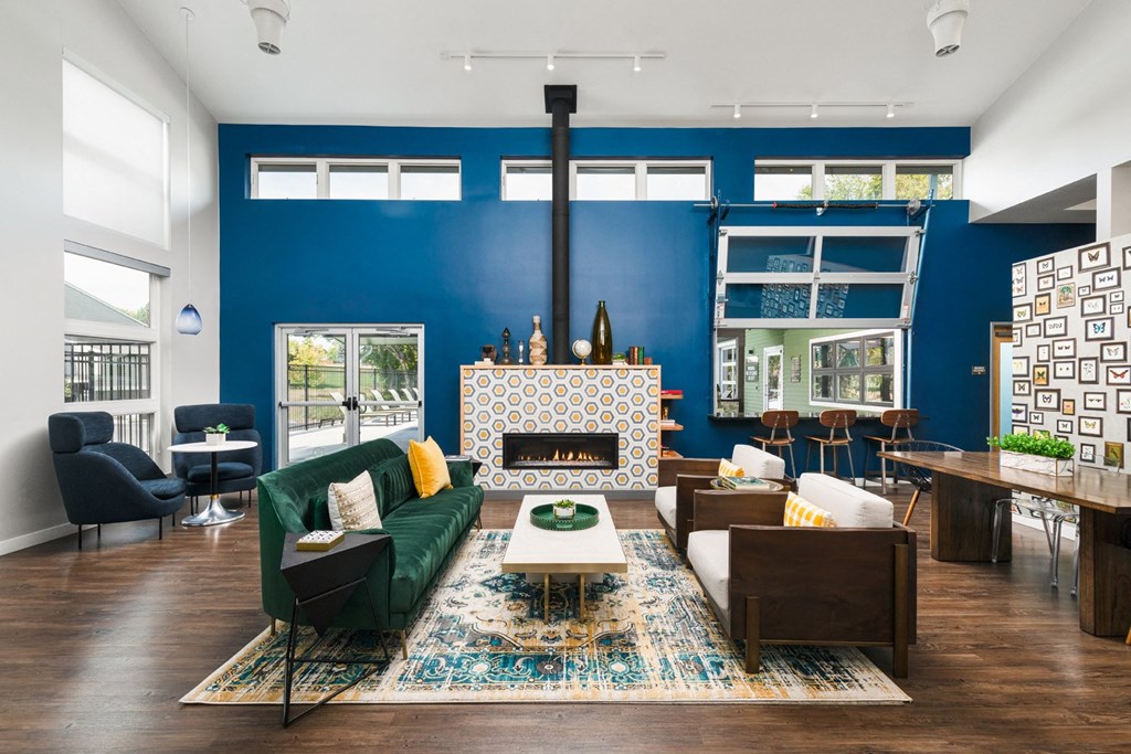 Clubhouse with Social Seating space and fire place with garage doors that lead to the pool area