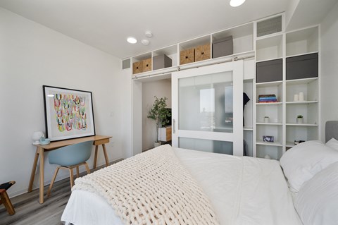 a bedroom with a large bed and a white closet
