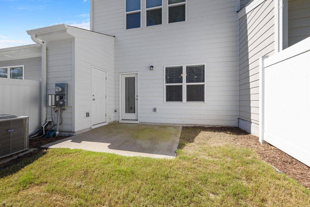 the entrance to a white house with a driveway