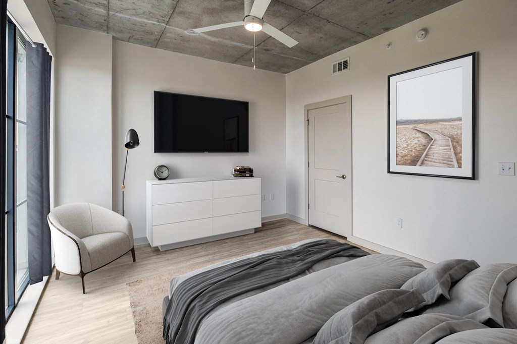 a bedroom with a large bed and a flat screen tv on the wall