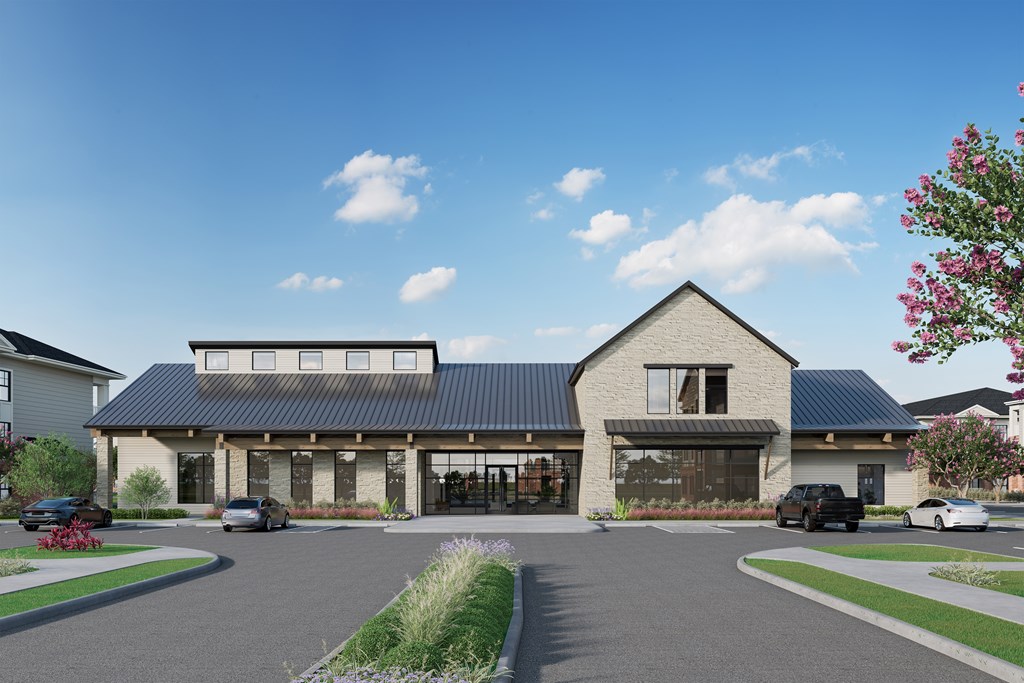 A modern building with a black roof and a parking lot in front.