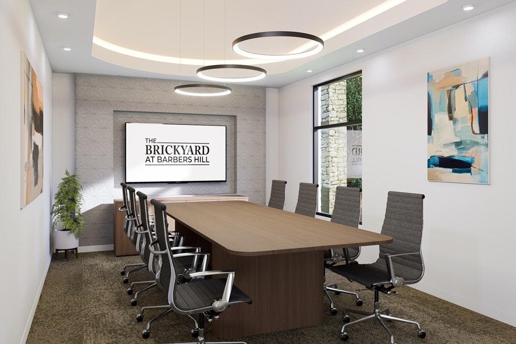 A conference room with a long table and chairs, and a sign that reads "The Brickyard at Barbers Hill.".