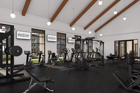 A gym with a variety of equipment including weights and machines.