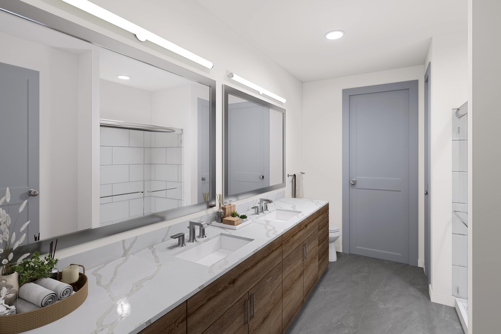 A bathroom with a double sink vanity and a large mirror.