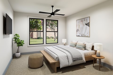 A bedroom with a large bed, a ceiling fan, and a window overlooking a garden.