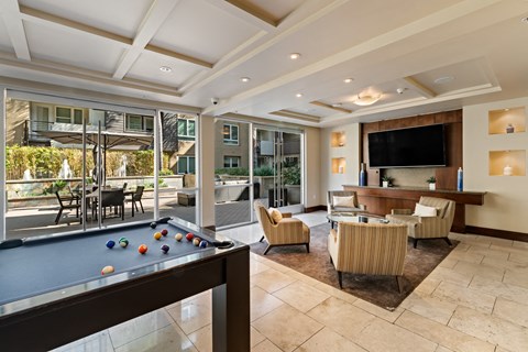 a large living room with a pool table and a tv