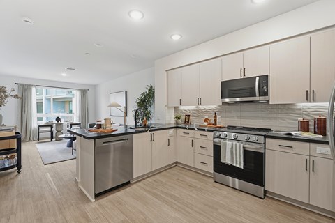 A modern kitchen with a large island and stainless steel appliances.