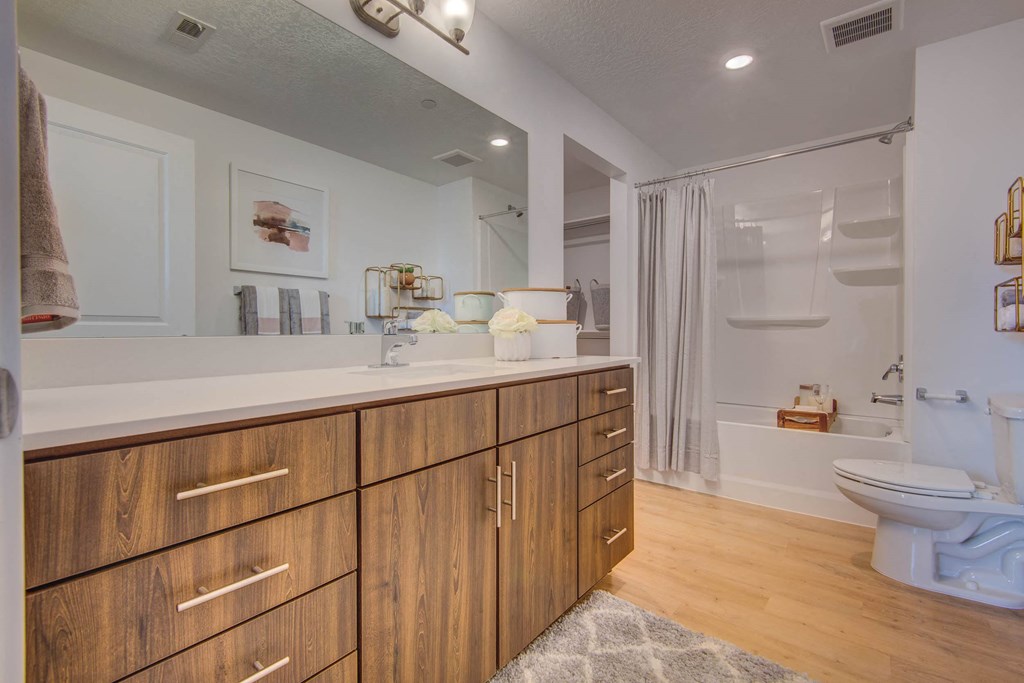 a bathroom with a toilet sink and shower