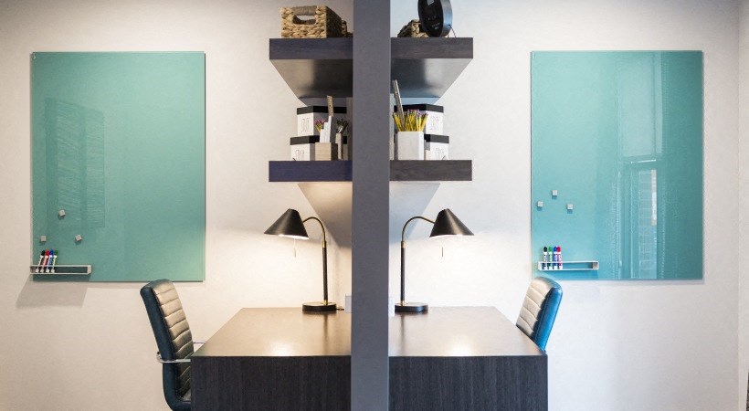 a conference room with a table and chairs and two lamps