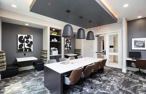 a conference room with a white table and chairs