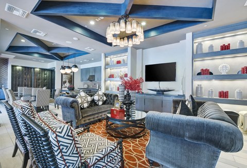 a living room with blue and white furniture and a tv
