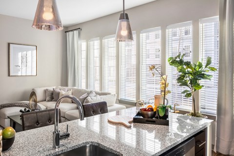 A kitchen with a granite countertop and a sink.