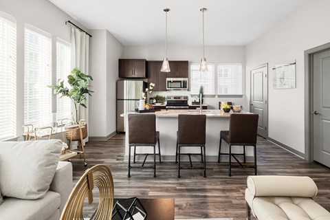 A modern kitchen with a dining table and chairs.