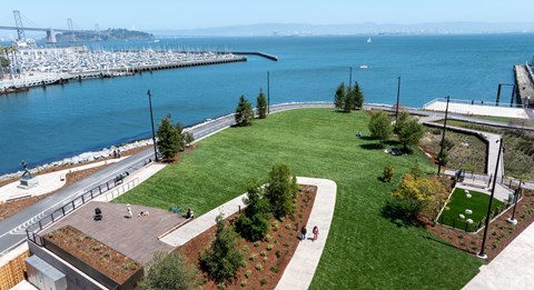 an aerial view of a park overlooking a body of water
