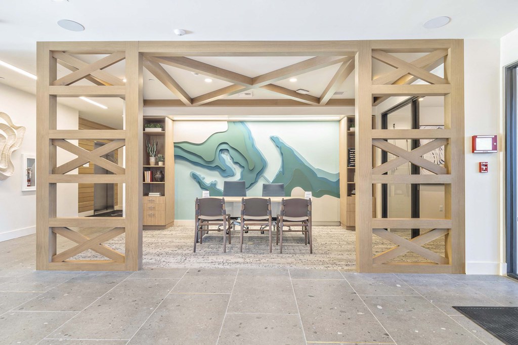 a dining room with a table and a painting on the wall