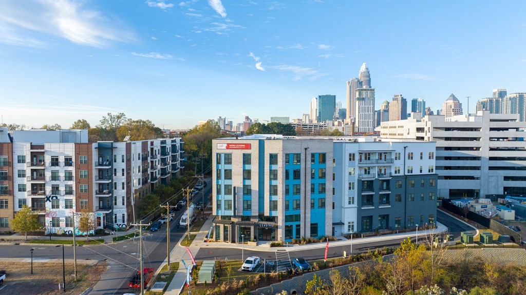 an aerial view of a building with a city in the background