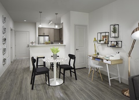 a dining room and kitchen with a table and chairs
