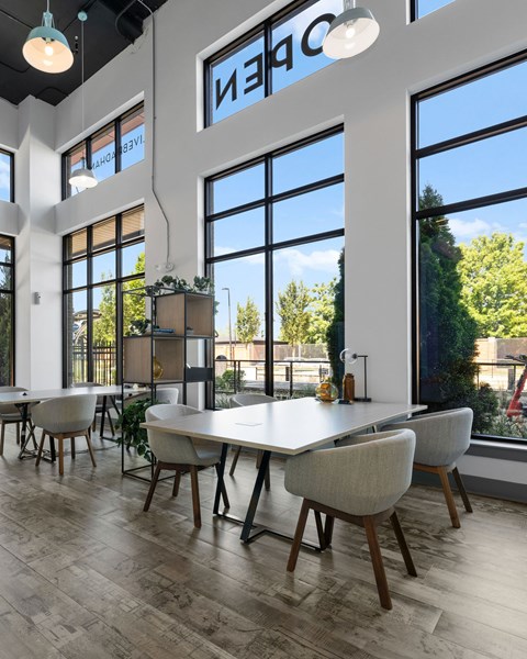 A modern dining room with a long table and chairs.
