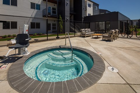 Small round pool with a waterfall in the middle at The Arvon, Vancouver, 98662