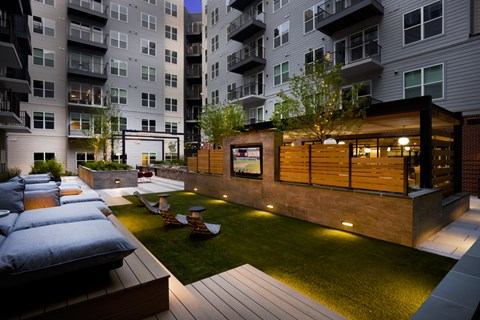 A modern outdoor living space with a wooden deck and seating area.