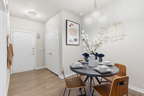 A dining room with a round table and chairs.