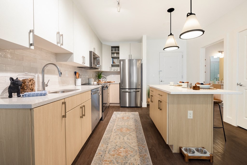 a kitchen with wooden cabinets and stainless steel appliances