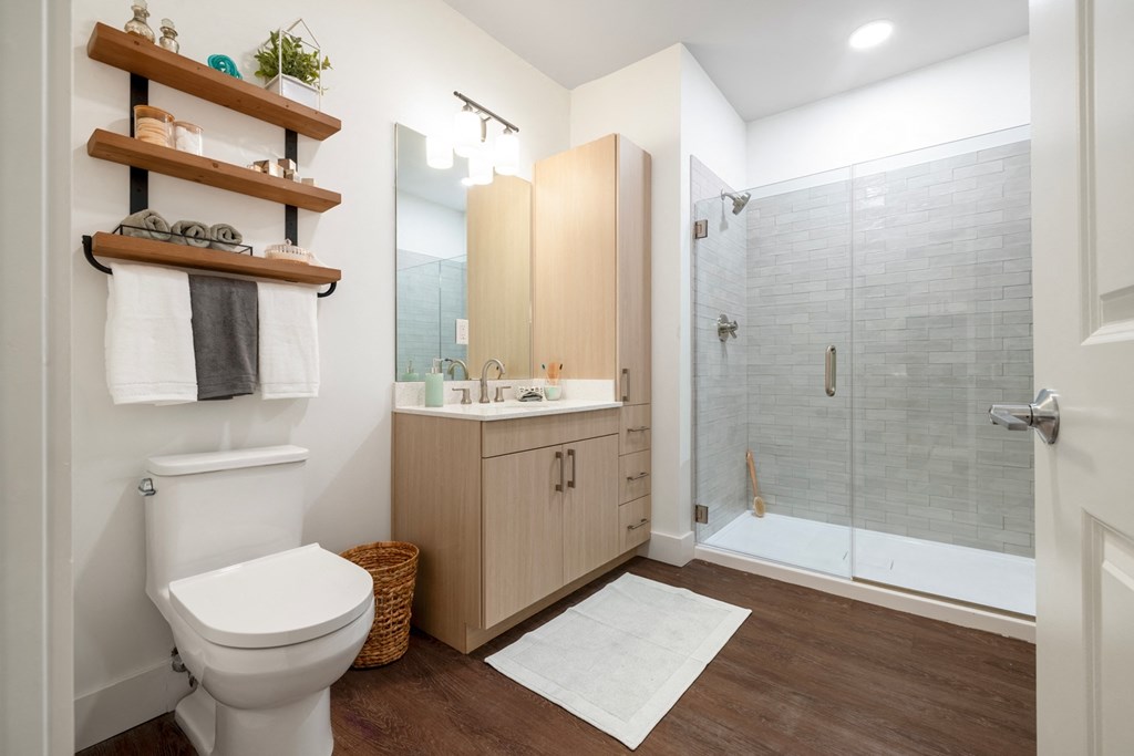 a bathroom with a toilet sink and shower
