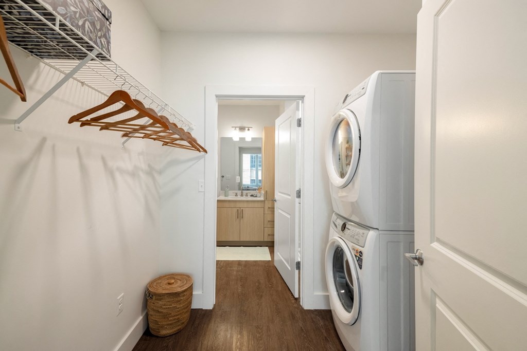 a washer and dryer in a laundry room with a white door and a