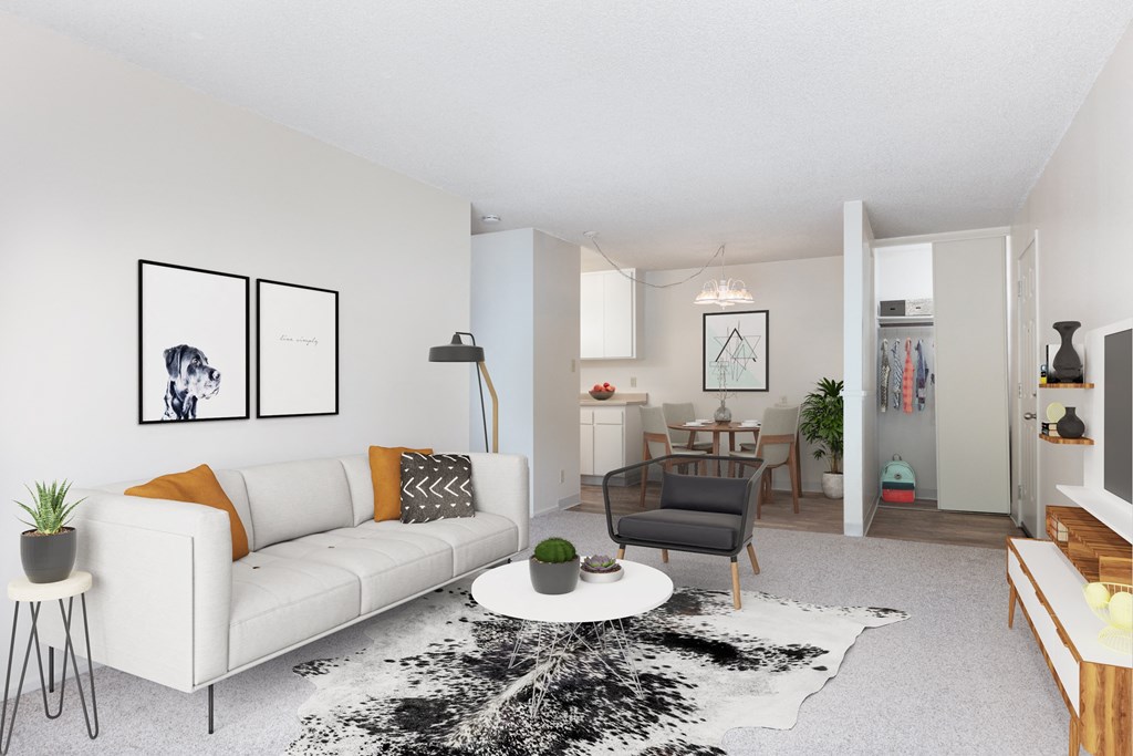 a living room with a white couch and a white coffee table