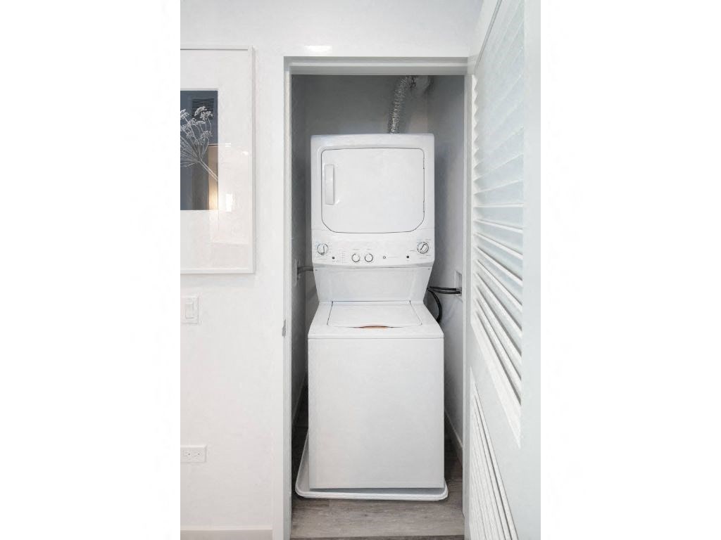 a white washer and dryer in a small room