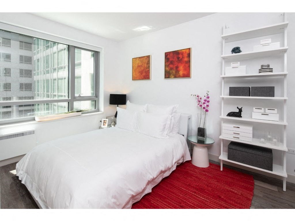 a bedroom with a bed and a window