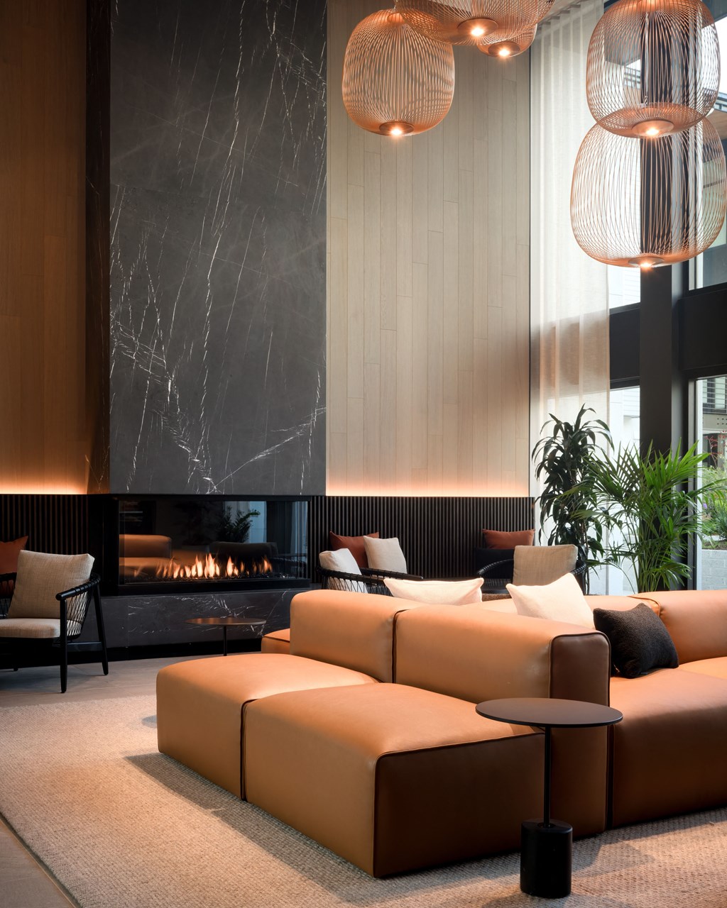 a large living room with couches and a fireplace