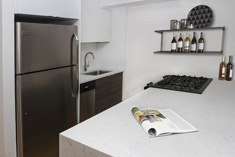 a kitchen with a counter top and a refrigerator